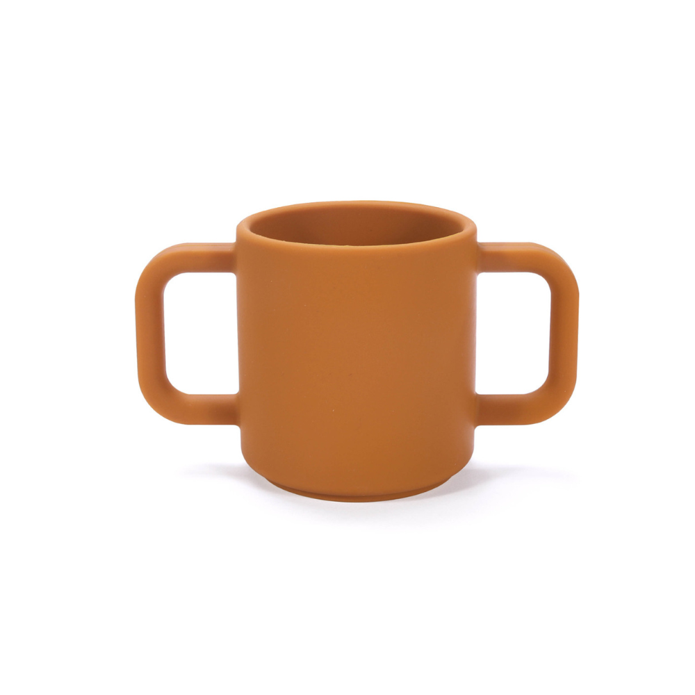 Premium Silicone Open Cup Brown. Premium silicone baby open cup in soft pink with a rounded rim, designed for toddlers learning to drink independently – unbreakable and easy to grip.